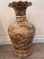 Front view of large Satsuma urn showing overall shape and floral motifs.