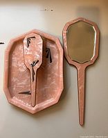 Pink marbled lucite Art Deco vanity set including handheld mirror and vanity tray, showing overall shape and design