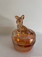 Iridescent marigold glass dish featuring Scottie dog on lid, side profile view.