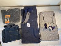 Lot contents showing four different men's vintage pants: navy bib overalls, Sear jeans, Buckeye jeans, and striped Big B Brotherhood bib overalls.