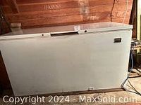 Front exterior view of white chest freezer with lid closed