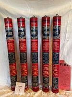 Set of six Liberty fire extinguishers standing upright showing front labels and instructions.