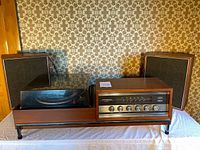 Vintage Garrard 2025TC stereo console with integrated turntable and speakers showing front view.