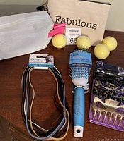 Photo showing Goody blow dry brush, Gentle Fit headbands in multiple colors, Fabulous cosmetic bag, lemon and mint bath bombs, and 3-piece Goody hair clips