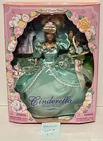 Front view of boxed Cinderella Garden Fantasy doll in mint green satin dress with floral accents and puffed sleeves.