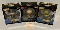 Three unopened DORBZ vinyl figures from Batman Series One: The Penguin #030, Killer Croc #092, and Aquaman #035, all still in original packaging.