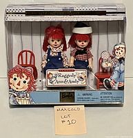 Front-facing photo of boxed Kelly and Tommy dolls as Raggedy Ann and Andy, showing box artwork, dolls, accessories, and original packaging.
