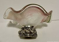 Side view of the Murano glass dish showing scalloped edges and metal base with leaf motif.