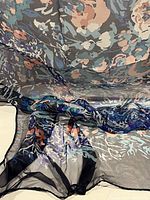 Floral multi-color silk scarf with shades of blue, pink, and purple, showing fine silk texture