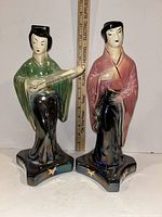 Front view showing both lusterware figurines standing next to a ruler, measuring about 10 inches tall.