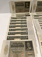 Front side of multiple 10,000 Mark Reichsbanknotes showing portraits and denomination text