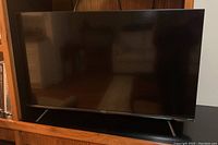 Front view of TV on stand showing screen and frame