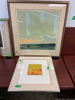 Two framed art prints displayed, one larger landscape print and one smaller abstract print with broken glass removed.
