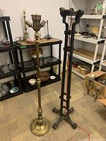 Photo showing the steel floor lamp with three socket heads next to the taller wrought iron Brutalist floor lamp with thick iron bars.