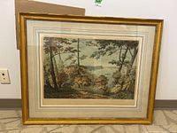 Full front view of framed landscape print with gold frame and triple mat