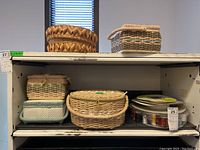 Five sewing baskets arranged on shelves, showing variety of basket shapes and sizes.