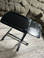 Closer angled view of the table top surfaces showing wear and discoloration marks on the black surfaces.