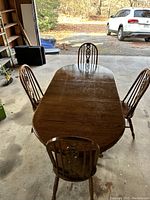 Long view of the solid wood dining table set in a garage area.