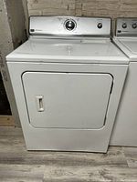Front view of the Maytag dryer showing the door, handle, and control panel.