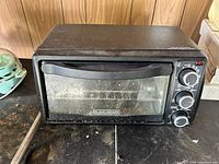 Front view of the Black & Decker toaster oven showing the exterior and control knobs.