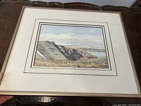 Front view of the framed painting showing the whole artwork, mat, and frame.