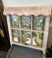 Full view of the watercolour collage painting in a six-pane old wood window frame.