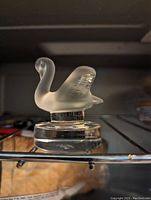 Side view of the frosted crystal swan figurine on clear base showing shape and condition.