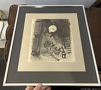 Framed lithograph with cream mat and silver metal frame, showing abstract still life artwork in brown and black.