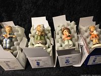 Four assorted 4-inch Hummel figurines in original boxes with protective foam cushioning