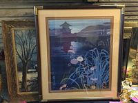 Framed Japanese print with triple matting and brass corners, showing a stylized nighttime floral scene and pagoda silhouette.