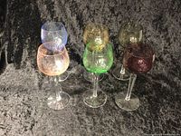Six colored lead crystal wine glasses in different colors arranged in a group.