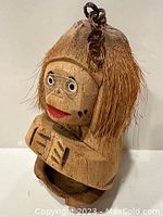 Front angled view of the coconut monkey key holder showing facial details, fiber hair, and open mouth key compartment.