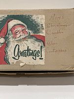 Original box with vintage Santa Claus image and handwritten label 'Mom's Christmas Candles in Glass Containers'