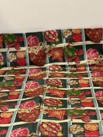 Photo showing the overall table cloth pattern with colorful Christmas ornaments in a grid layout on a green background.