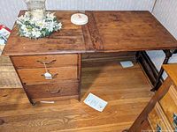 Full view of the antique Larkin drop leaf sewing table showing the one drawer and drop leaf extended for a larger work surface.