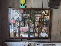 Full view of the wooden printer's tray shadow box with all compartments and displayed items behind glass.
