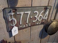 Front view of the single 1942 Massachusetts license plate showing number 577-364 with some patina and wear.