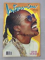 Front cover showing Stevie Wonder portrait and black Sharpie signature.