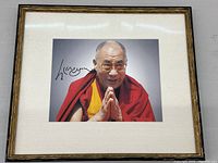 Full view of framed photograph showing the Dalai Lama in mat and frame