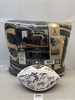 Packaged New Orleans Saints black and gold three-piece bedding set with comforter and shams, football in front