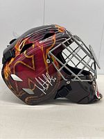 Left-side view showing full red and black flame design and autograph