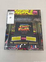 Front of the collectors book with slipcase showing arcade cabinet design and title