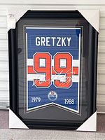 Front view of framed banner art still in protective corner packaging