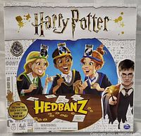 Front of the Harry Potter Hedbanz game box featuring cartoon children wearing headbands and Harry Potter character image.