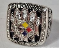 Front angled shot of the Pittsburgh Steelers replica championship ring showing the team logo with colored enamel and rhinestone decoration