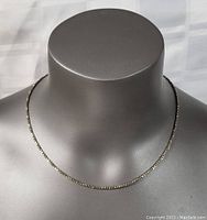 Necklace displayed on mannequin neck, showing length and style.