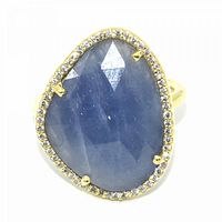 Close-up front view of the gold plated ring with large faceted blue sapphire CZ surrounded by small clear stones.