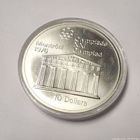 Obverse side showing classical architecture with Olympic rings, Montreal 1976 text, and denomination 10 dollars.
