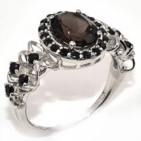 Side angled view showing the central smokey quartz and surrounding black spinel stones with the rhodium plated silver band.