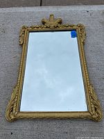 Front view of mirror laid flat on concrete surface